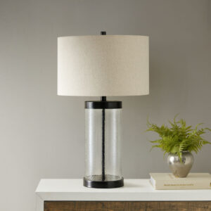 Add an elegant charm to your home with the INK+IVY Macon Glass Cylinder Table Lamp. This stylish table lamp is made from a painted bronze metal and a clear glass base that adds dimension and charm. A drum shade shape helps accentuate the design. Illuminate your living room or bedroom with this gorgeous table lamp. One Type A light bulb is needed and included.