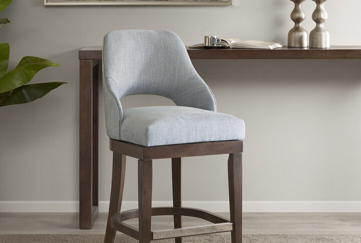 The Madison Park Jillian Counter Stool provides a simply stylish update to your dining area. This counter stool features an open back design and rectangular seat in beautiful blue upholstery. The straight rubber wood legs create a sturdy base and sport a Morocco finish to complete the look