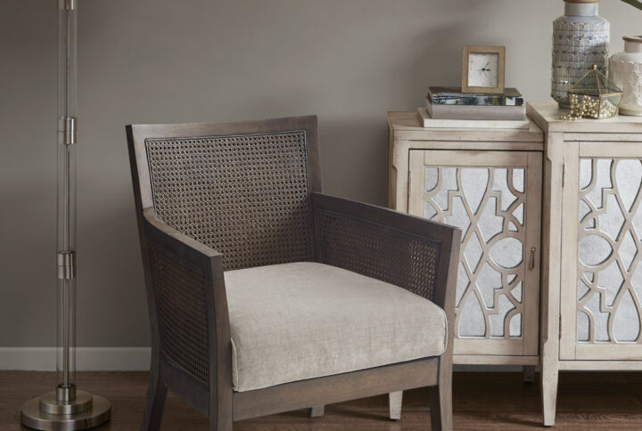 Relax in the comfort and simple style of the Madison Park Diedra Cane Armchair. The unique cane back and sides feature an espresso wood finish