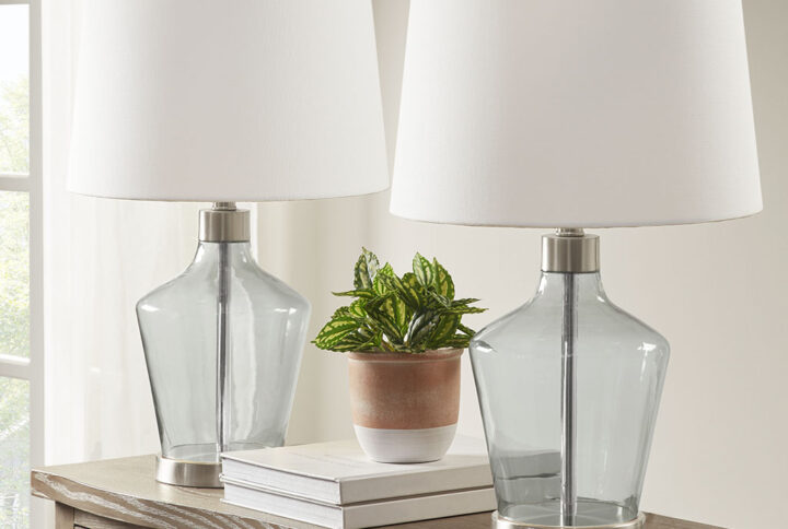 Update your living room or bedroom with the sleek style of the 510 Design Harmony Angular Glass Table Lamp