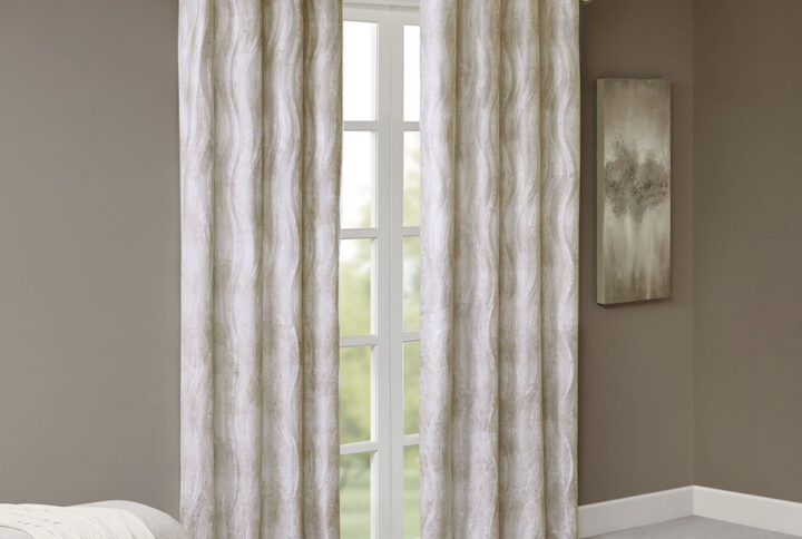 Keep cool and comfortable with the chic style of the SunSmart Victorio Jacquard Total Blackout Window Panel. This ivory total blackout window panel features a soft modern wavy brush stroke design with a luxe sheen and texture for a modern glam look. The knitted jacquard fabric is heavyweight with a 100% blackout finish to block out all outside light