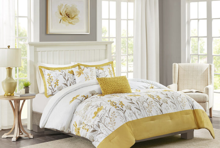 The Harbor House Meadow 5 Piece Cotton Comforter Set offers a charming farmhouse style update for your bedroom decor. This cotton sateen comforter features a botanic print in taupe and yellow hues on a white ground and a yellow border at the foot