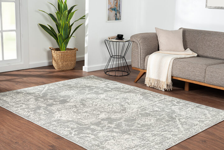 Soften your space with the Madison Park Asher Distressed Medallion Cream and Grey Woven Area Rug. Made in Turkey