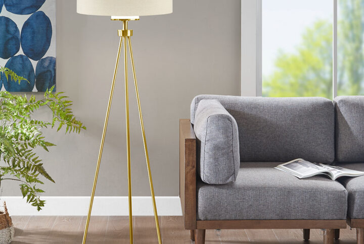 The Pacific Metal Tripod Floor Lamp with Glass Shade is the perfect update of urban sophistication to any room. A metal base is featured in a gold finish