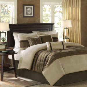 The Madison Park Palmer 7 Piece Comforter Set offers a classic and refined update to your bedroom decor. This transitional style comforter features a pieced microsuede design in rich contrasting taupe and brown colors to create an incredibly soft look and feel. The 2 matching shams also flaunt a pieced construction to coordinate with the faux suede comforter. A solid brown bed skirt and 3 decorative pillows with a mix of embroidered designs add the perfect finishing touches to complete this lush traditionally-inspired comforter. Machine washable for easy care