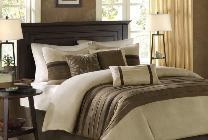 The Madison Park Palmer 7 Piece Comforter Set offers a classic and refined update to your bedroom decor. This transitional style comforter features a pieced microsuede design in rich contrasting taupe and brown colors to create an incredibly soft look and feel. The 2 matching shams also flaunt a pieced construction to coordinate with the faux suede comforter. A solid brown bed skirt and 3 decorative pillows with a mix of embroidered designs add the perfect finishing touches to complete this lush traditionally-inspired comforter. Machine washable for easy care