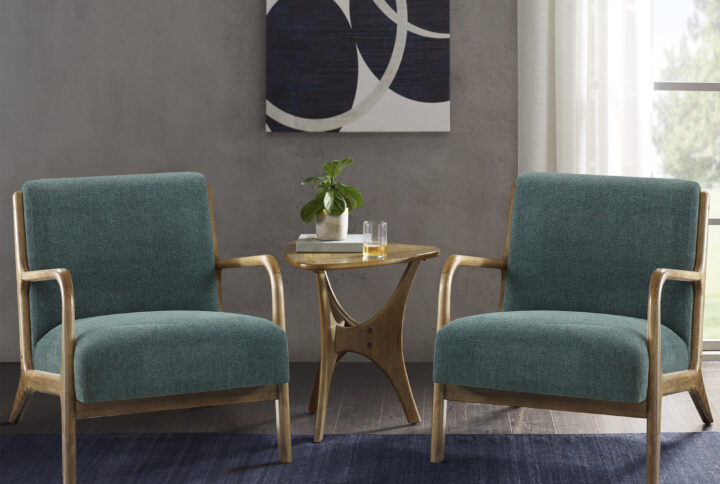 Sit back and relax in the comfort and mid-century style of the INK+IVY Novak Lounge Chair. This lounge chair features a soft upholstered seat and back. The upholstery is beautifully complemented by elm wood finish on the solid wood frame and round arms