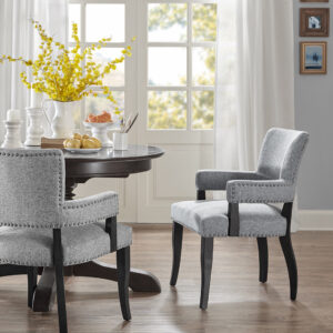 This nail head-outlined dining chair has a smart