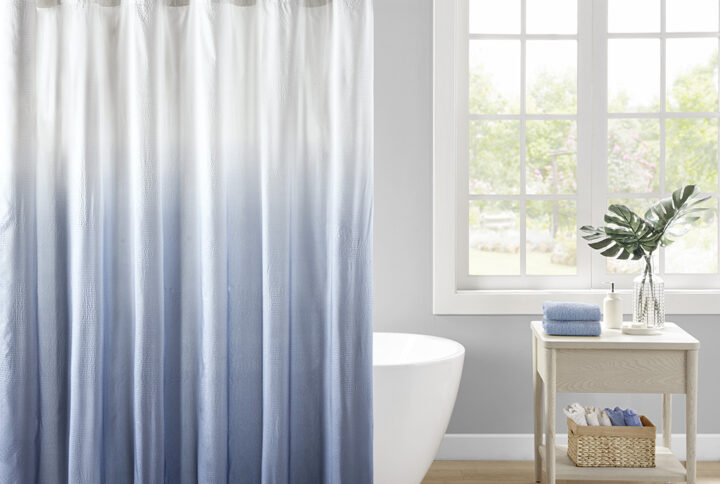 Add a refreshing touch to your bathroom decor with our Madison Park Ara Ombre Printed Seersucker Shower Curtain. This shower curtain features a blue ombre print on an embossed seersucker fabric