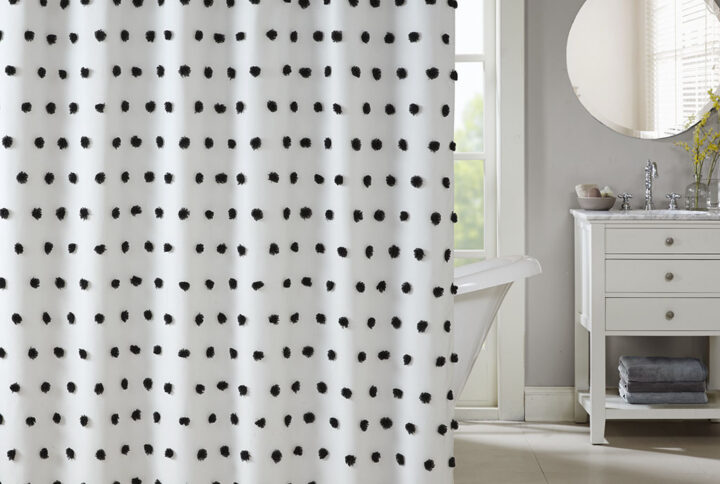 Add a fun update to your space with the Madison Park Sophie shower curtain. The solid white background features rows of soft black fabric pom poms