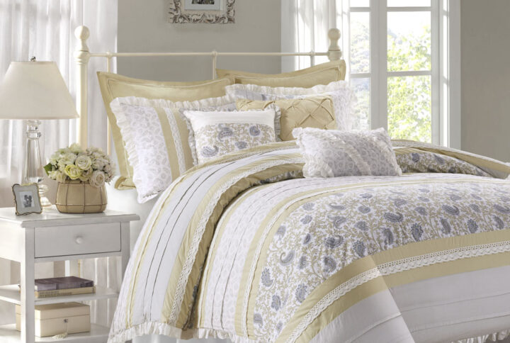 The Madison Park Dawn 9 Piece Cotton Percale Comforter Set offers a shabby chic update to your bedroom decor. A paisley print is featured on the cotton comforter with pintucked fabric separated by lace taping embellishments. Around the edge