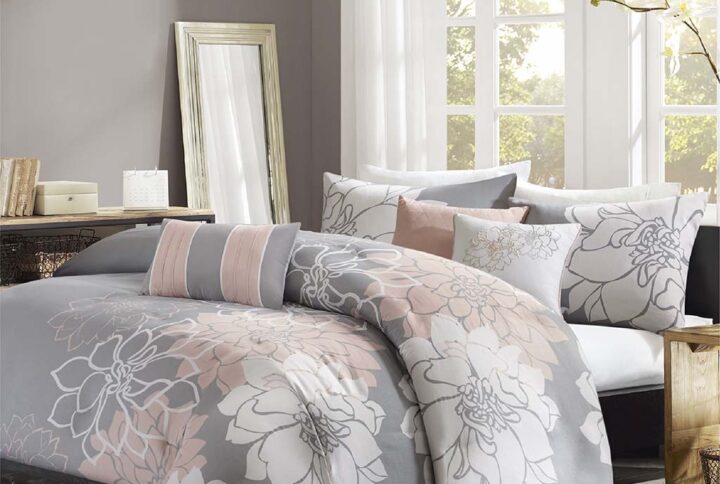 The Madison Park Lola 6 Piece Printed Duvet Cover Set transforms your bedroom into a beautiful and graceful space. A gorgeous floral print in a soft white and peach hue pops against the solid grey ground cotton duvet cover and shams for a stunning transitional look. Three decorative pillows with embroidered details and fabric manipulation add texture and dimension to the bed