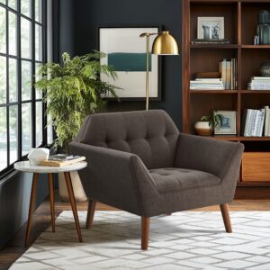 Elevate your living area with the mid-century allure of the INK+IVY Newport Upholstered Armchair. Featuring a wide 37-inch profile and a striking angular silhouette