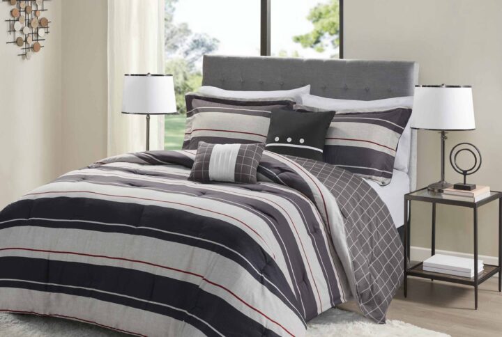 The Madison Park Essentials Dalton Reversible Comforter Set offers a total transformation and modern update to your bedroom. The ultra-soft microfiber comforter features ombre grey and charcoal stripes on the face with a windowpane print on the reverse