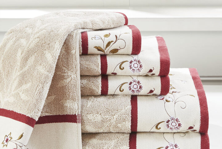 Add a touch of elegance to your bathroom decor with our Madison Park Serene Embroidered Cotton Jacquard 6 Piece Towel Set. These cotton towels feature a jacquard leaf pattern with a floral embroidered hem