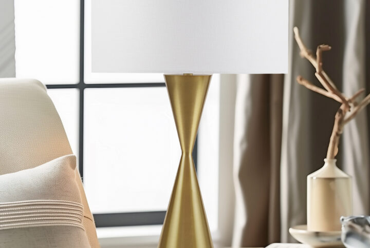 Introducing the Elixir Table Lamp by INK+IVY: a masterpiece of sophistication with its antique gold base and a captivating hourglass silhouette