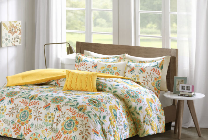 Update your bedroom with the warm and bright charm of the Intelligent Design Nina Comforter Set. The soft white microfiber comforter features a floral medallion and bird print in vivid colors with a solid yellow reverse