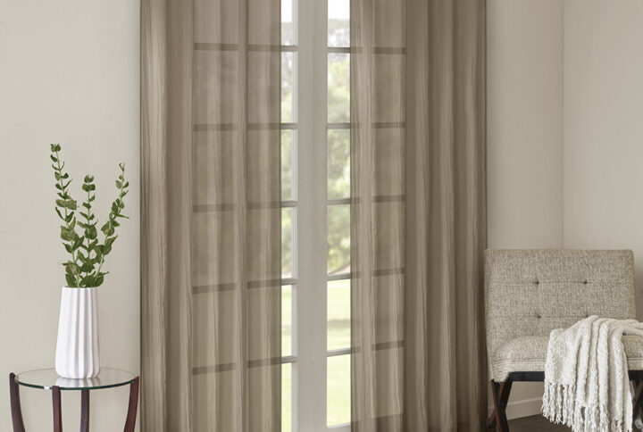 Add a fresh contemporary style to your home with Madison Park’s Harper Solid Crushed Window Panel Pair. Made from a lightweight taupe sheer fabric