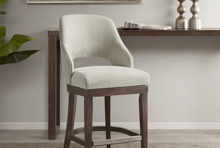 The Madison Park Jillian Counter Stool provides a simple and stylish update to your dining area. This counter stool features an open back design and rectangular seat in rich cream upholstery