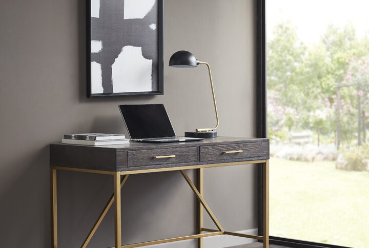 Complete your office décor with modern style of the Martha Stewart Sharkey Desk. This desk features a solid wood veneer top in a dark morocco finish and a gold metal frame