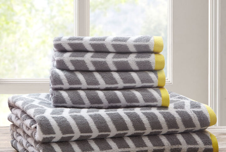 Add the Intelligent Design Nadia 6 Piece Towel Set to your bathroom for a fun and bright update! These 2-ply ring spun towels are cotton jacquard woven making them reversible in contrasting colors as well as incredibly absorbent. Each towel features a rich grey color geometric print with a small dobby border. These cotton towels are also Made in Green by OEKO-TEX certified