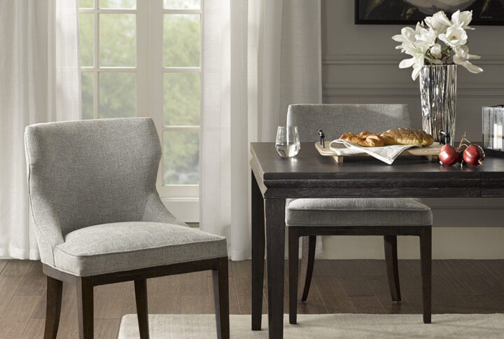 Complete your dining room decor with the Madison Park Signature Hutton Dining Side Chair Set. These traditional dining chairs sport and tight back and seat creating an elegant look. The grey upholstery beautifully contrasts with the burnt walnut finish on the wooden legs. With a stunning design that appeals to most décors