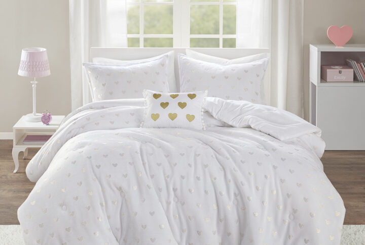 The Mi Zone Rosalie Metallic Printed Plush Comforter Set brings a bright and casual update to your bedroom. A gold metallic heart print adorns the white plush comforter and shams (1 in Twin/TwinXL) creating a soft and fun look. An oblong decorative pillow with a pompom trim and embroidered hearts adds a lovely touch to the bedding set. The hypoallergenic polyester comforter filling contains no allergens and is treated to be dustproof