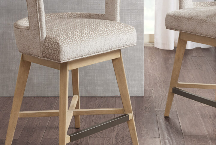 Update your kitchen dining decor with the Madison Park Glenwood Swivel Counter Stool. This counter stool features a low open back and is upholstered in a rich cream fabric for a charming contemporary look. The solid wood legs complement the upholstery with the wheat color finish