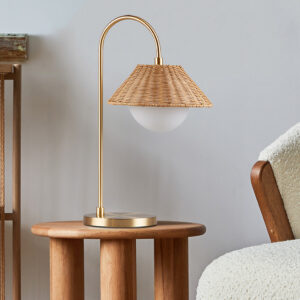 Introducing the Laguna rattan weave shade table lamp from Ink+Ivy - a versatile and stylish lighting solution that will complement any decor. Made from durable iron in a modern gold finish