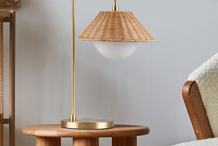 Introducing the Laguna rattan weave shade table lamp from Ink+Ivy - a versatile and stylish lighting solution that will complement any decor. Made from durable iron in a modern gold finish