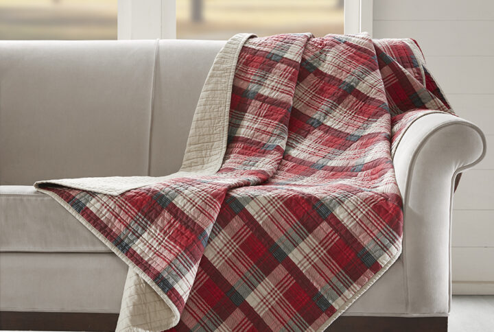 The Woolrich Tasha quilted throw features an all over red and tan plaid and reverses to a solid tan color. Made from 100% cotton this lightweight throw is soft to the touch and can be used year round.