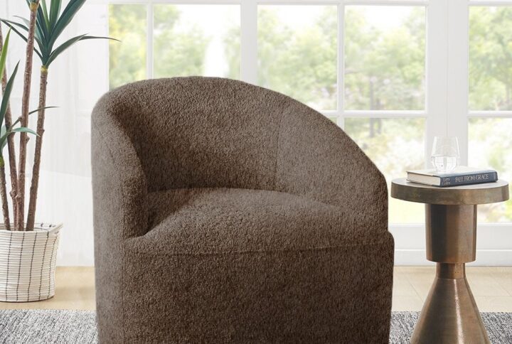 Add a comfortable and casual flair to your home with this swivel chair. This barrel-style chair is upholstered in a soft textured boucle fabric and has a tight attached seat to create a modern minimalist look. The sloped arms provide additional comfort to make this motion chair stylish and cozy. A hidden swivel base helps maintain the clean and seamless silhouette