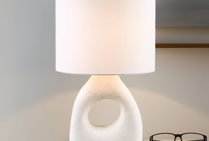 Brighten up your home with the INK+IVY Trilluxe Ceramic Table Lamp. This contemporary masterpiece features a uniquely shaped ceramic base in a textured matte-white finish