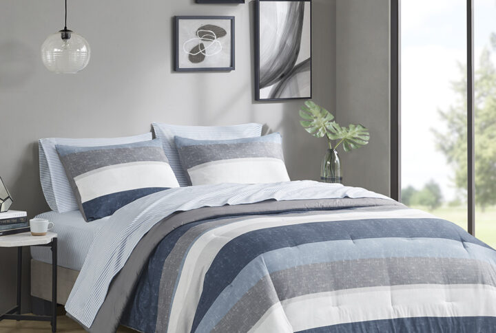 Revamp your bedroom style with the Madison Park Essentials Jaxon bed in a bag. This modern comforter set features a stripe pattern in alternating grey