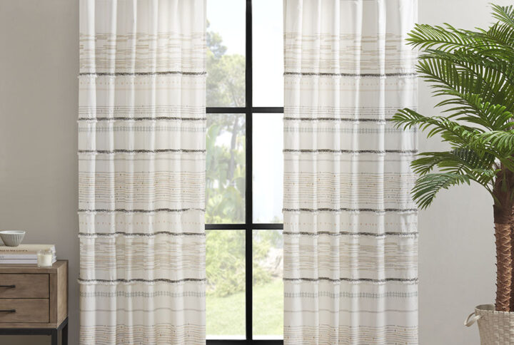 Elevate your home decor with the modern boho style of our INK+IVY Nea Cotton Printed Tassel Trim and Lined Window Curtain. This off white/gray cotton window panel features fresh printed stripes and tassel detailing creating a rich artisanal texture