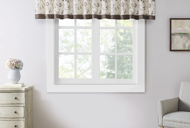 Add simple elegance to any room with the Madison Park Serene Embroidered Valance. This valance features delicate floral embroidery in rich red and natural hues