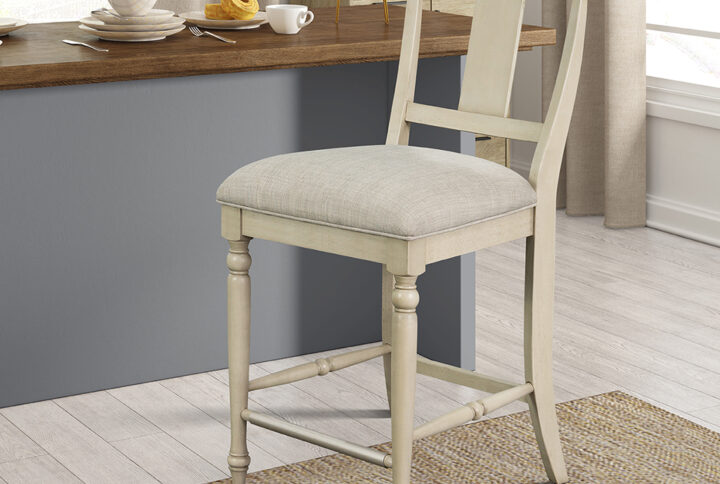 The Martha Stewart Fiona Counter Stool offers a classic farmhouse update to your dining room decor. This counter stool features an upholstered seat and solid wood frame