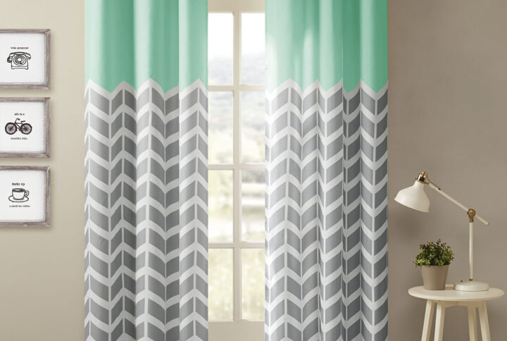 Our Intelligent Design Alex Chevron Printed Room Darkening Panel Pair adds bright color and fun style to your room. These window panels feature a contrast color chevron print with solid top border