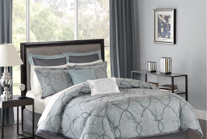 The Madison Park Lavine 12 Piece Bedding Collection gives your bedroom a rich and luxurious makeover. The comforter features a greyish blue jacquard woven fabric with a 3D effect created by a damask design in light and dark grey. The two pillow shams match the comforter design to enhance the luxury style. Two decorative pillows with embroidery and fabric manipulation details coordinate with the two euro shams for a stunning bedroom look. The set also comes with a complete ivory 100% cotton sheet set that adds a cozy touch to the bedding set. The items in the set may arrive in a rolled or compressed form