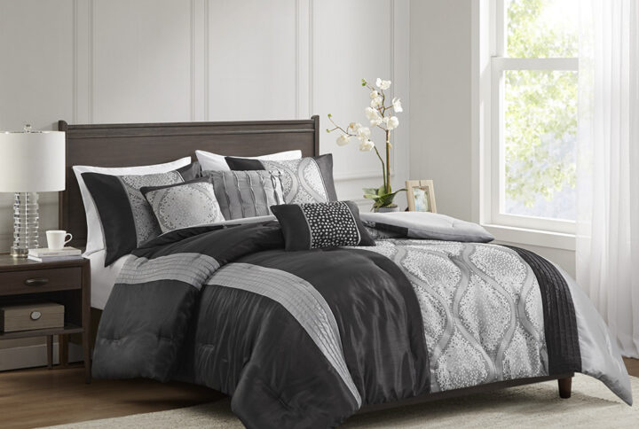 This traditional jacquard comforter set features an elegant ogee design pieced with solid stripes in a vertical layout for an opulent bedroom update. The three throw pillows featuring pintucks