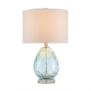 this glass table lamp flaunts a gorgeous blue and green hue that adds a soft touch of color to your room. The white drum-shaped lamp shade tastefully accents the base