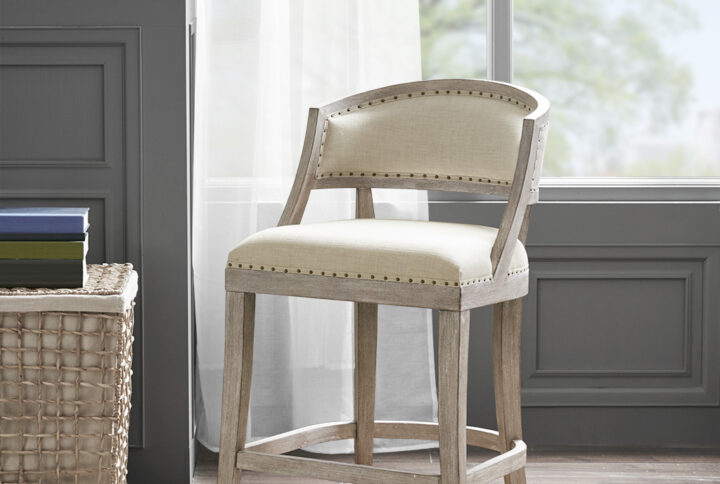 Give your dining space a warm and welcoming touch with the Madison Park Tuscan Counter Stool. This counter stool is upholstered in a natural-hued fabric that is complemented by the reclaimed biscuit wood finish on the solid wood legs and frame. A bronze nail head trim adds an elegant touch to the design