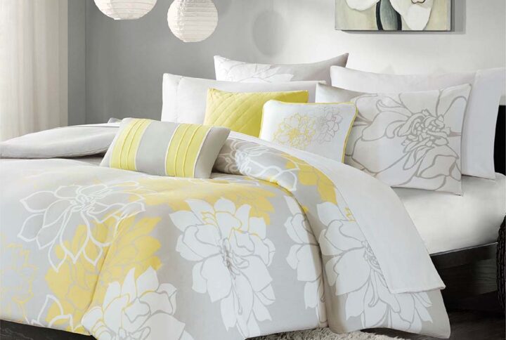 The Madison Park Lola 6 Piece Printed Duvet Cover Set transforms your bedroom into a beautiful and graceful space. A gorgeous floral print in a soft white and yellow hue pops against the solid taupe grey ground cotton duvet cover and shams for a stunning transitional look. Three decorative pillows with embroidered details and fabric manipulation add texture and dimension to the bed