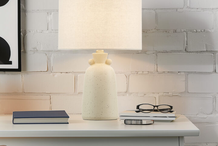 Brighten your space with the Ink+Ivy Alarid accent table lamp. Its ceramic base