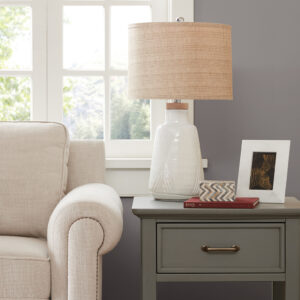 Fun details and unique style bring the INK+IVY Tate Boho Textured Ceramic Table Lamp to life. A subtle white ceramic base is complimented with touching V shapes and a natural wood top. This is a lamp that can be used in a multitude of decors. The natural tan textured shade and round finial round out this lamp.