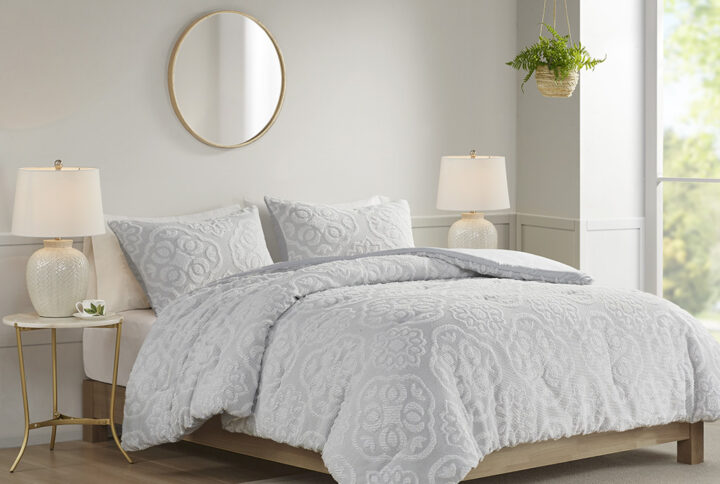 This shabby chic farmhouse style comforter set features a tufted white medallion pattern on top of tightly woven black and white threads