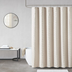 Elevate your bathroom decor with the Madison Park Metro Woven Clipped Solid Shower Curtain. This solid sand color shower curtain features a woven square geometric design with a clipped treatment to create beautiful texture and dimension