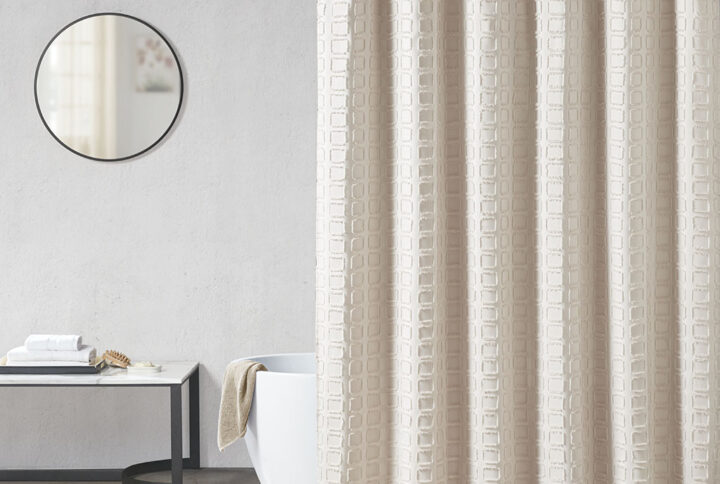 Elevate your bathroom decor with the Madison Park Metro Woven Clipped Solid Shower Curtain. This solid sand color shower curtain features a woven square geometric design with a clipped treatment to create beautiful texture and dimension