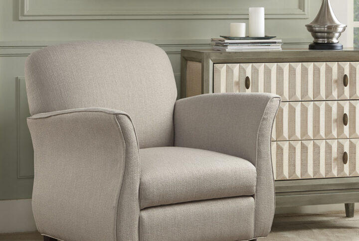 The Madison Park Escher Accent Chair brings a touch of elegance to your home decor. This accent chair is upholstered in a rich cream fabric and features flared arms that create a sharp transitional look. The solid wood legs provide a sturdy base