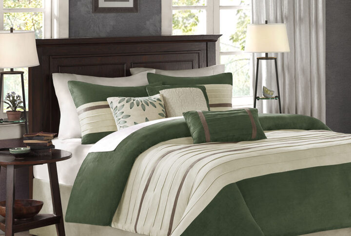 The Madison Park Palmer 7 Piece Comforter Set offers a classic and refined update to your bedroom decor. This transitional style comforter features a pieced microsuede design in rich contrasting green and beige colors to create an incredibly soft look and feel. The 2 matching shams also flaunt a pieced construction to coordinate with the faux suede comforter. A solid beige bed skirt and 3 decorative pillows with a mix of embroidered designs add the perfect finishing touches to complete this lush traditionally-inspired comforter. Machine washable for easy care